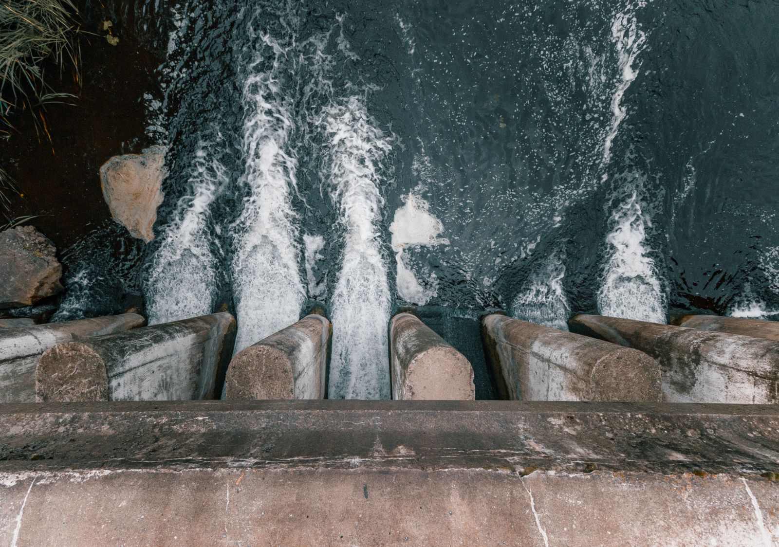 Aerial view of water cascading over a concrete hydroelectric dam